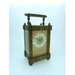 A French gilt brass Carriage Clock, of architectural form with fluted columns, the circular dial