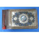 An early 20thC Persian Album Folder, decorated with an applied enamel centre medallion of a