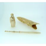 An antique European carved ivory figure of a Woman holding a brace of fish, 2½in (6.25cm) high,