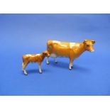 A Beswick pottery Guernsey Cow, MN.1248A, second version, gloss, 4¼in (10.75cm) high, together