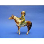 A Beswick pottery Mounted Indian, MN.1391, gloss, factory glazed chip to headdress, 8½in (21.5cm)