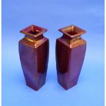 A pair of early Carter & Co. Poole pottery red lustre Vases, each of square baluster form, incised