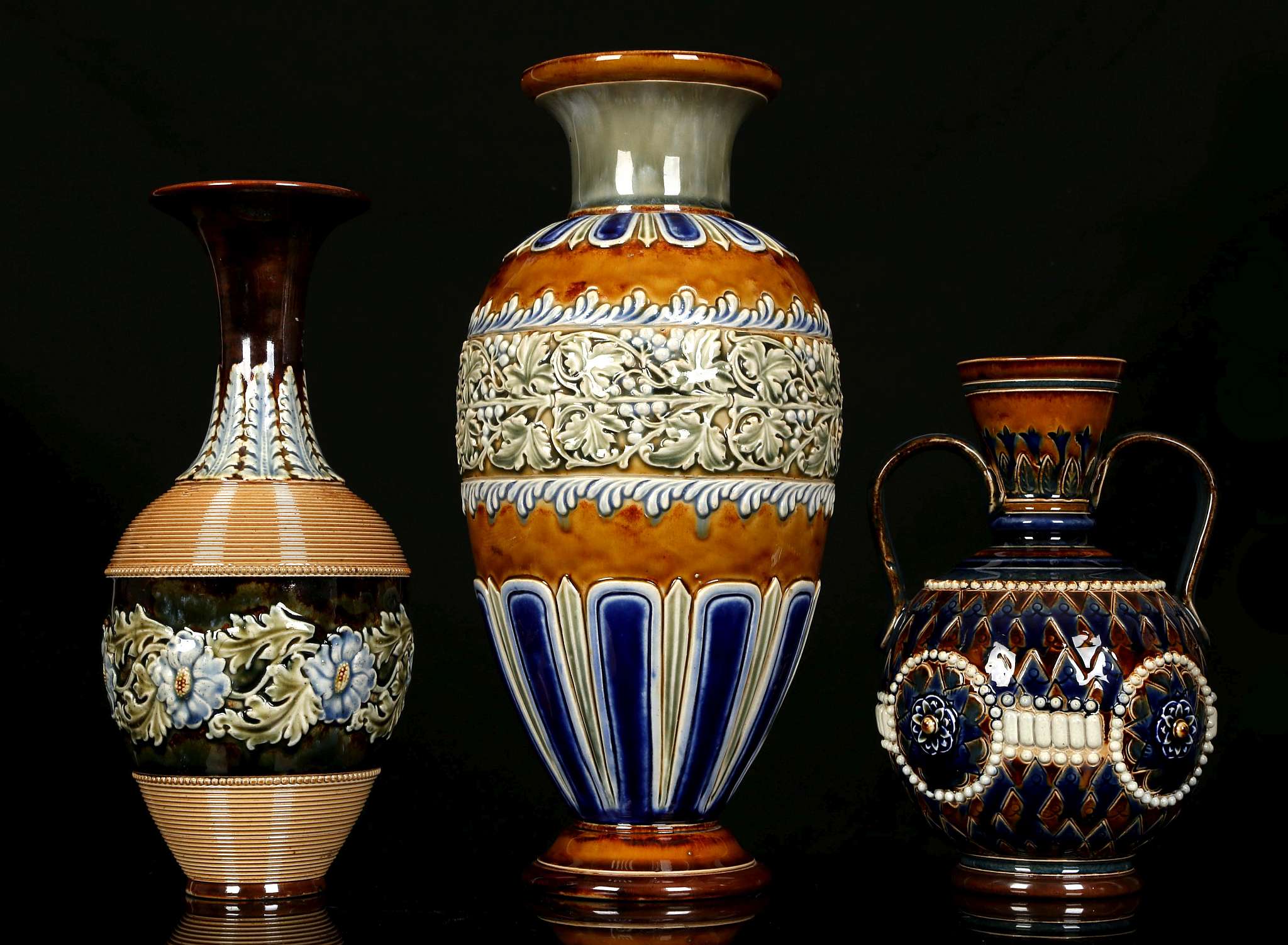 THREE DOULTON LAMBETH VASES, early 20th century, comprising a large baluster vase decorated with a