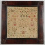 A William IV period child's sampler, bearing the name Mary Waddington and including the tree of life