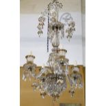 A Persian glass style chandelier with six scrolling arms, decorated with white enamel and