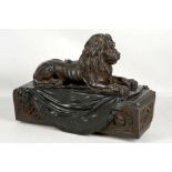 An iron model of a lion mounted onto a regency style base. 23.5 high x 31cm long.