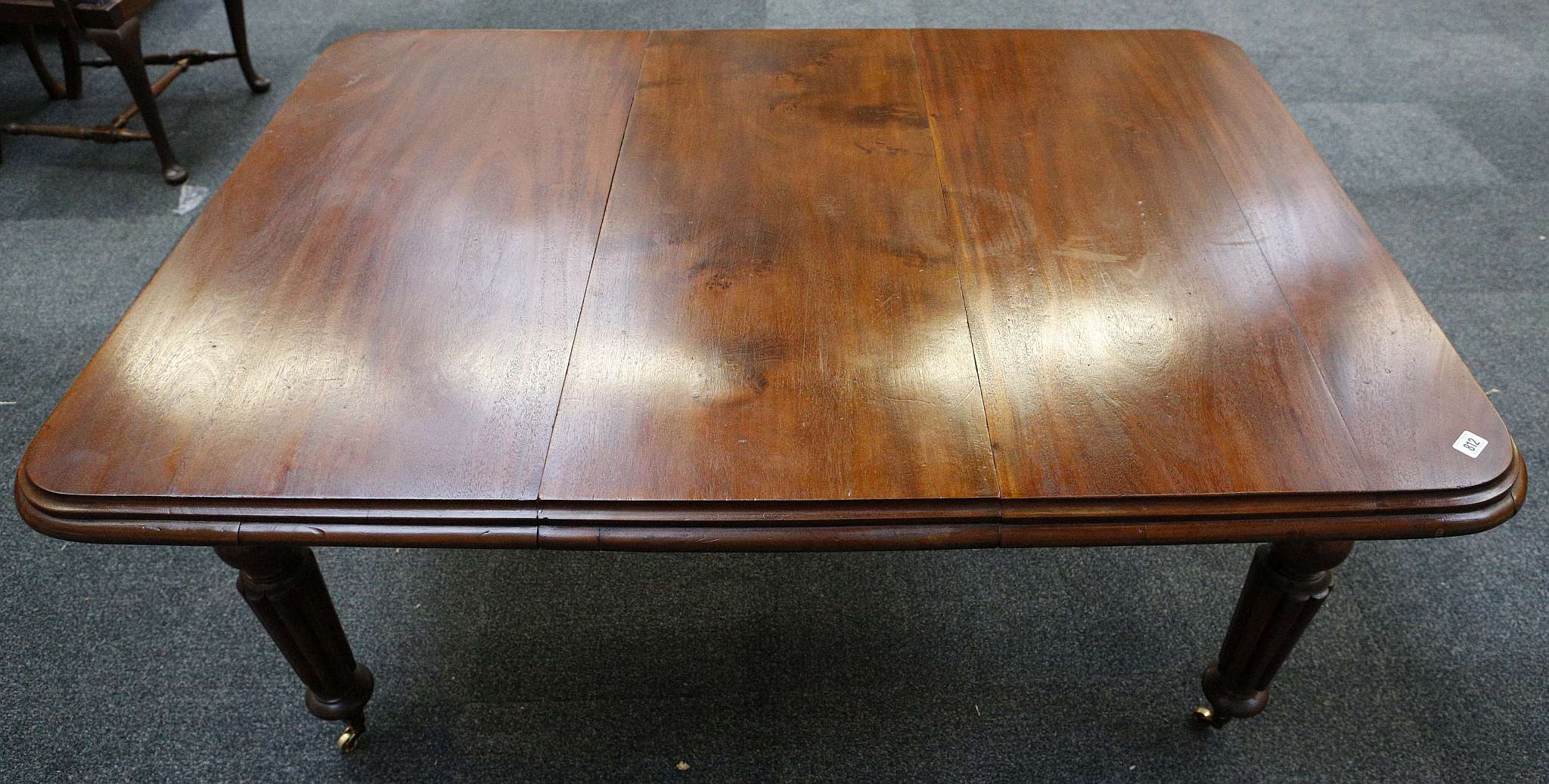 A Victorian wind out dining table, mahogany, rounded corners, tapering turned and reeded legs, brass - Image 2 of 2