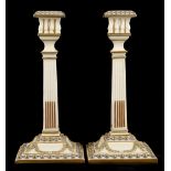 A pair of mid-Victorian Royal Worcester porcelain candlesticks, applied with neo-classical raised