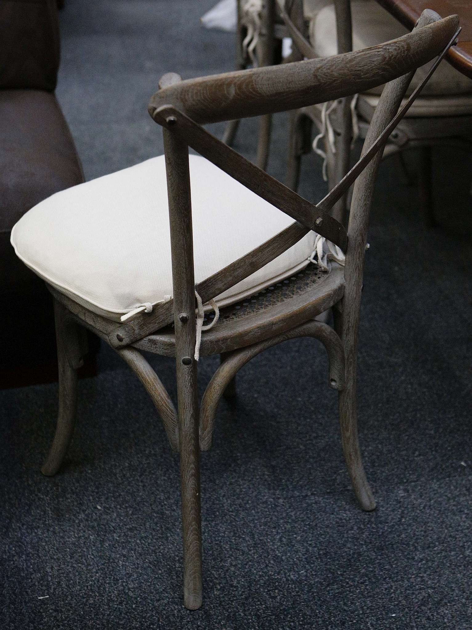 A set of six grey painted dining chairs with squab cushions on a splayed circular section legs. - Image 2 of 2