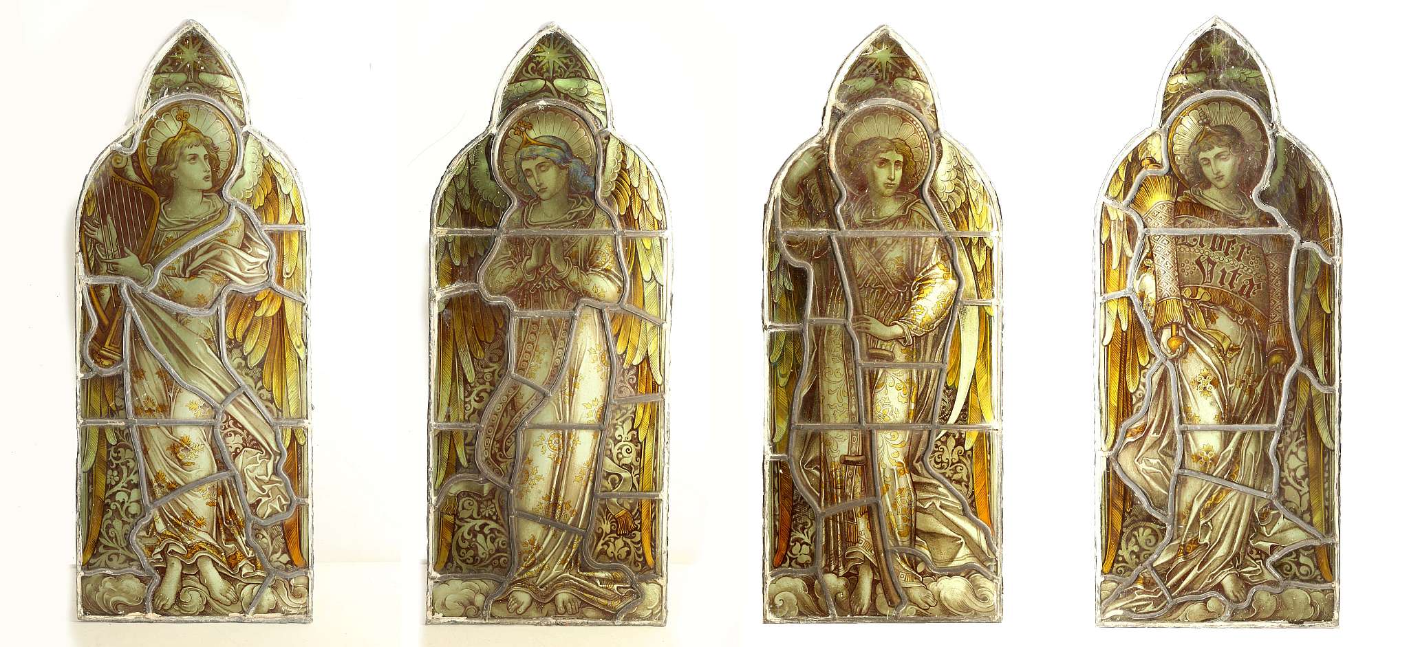 AN EXCEPTIONAL SET OF FOUR AESTHETIC PERIOD ECCLESIASTICAL PAINTED AND LEADED GLASS WINDOW PANELS,