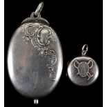 A pair of early 20th century sterling silver lockets. One with jockey's cap and crop - racing