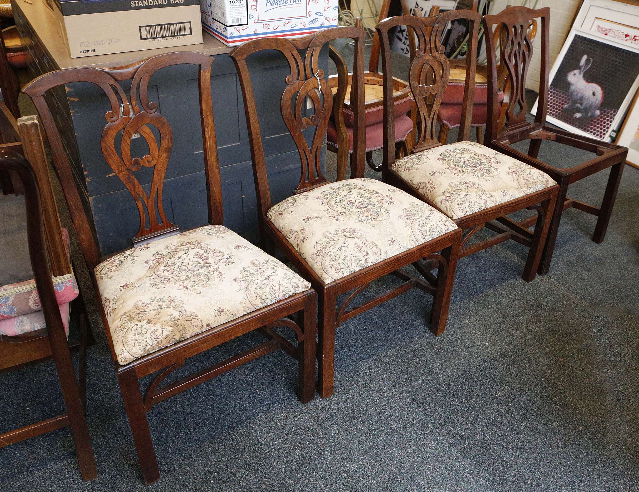 A 'Harlequin' set of four 19th century elm dining chairs with pierced scrolling splat backs,