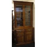 An Edwardian glazed book cupboard, light mahogany, double doors over drawers and doors. 243cm high.
