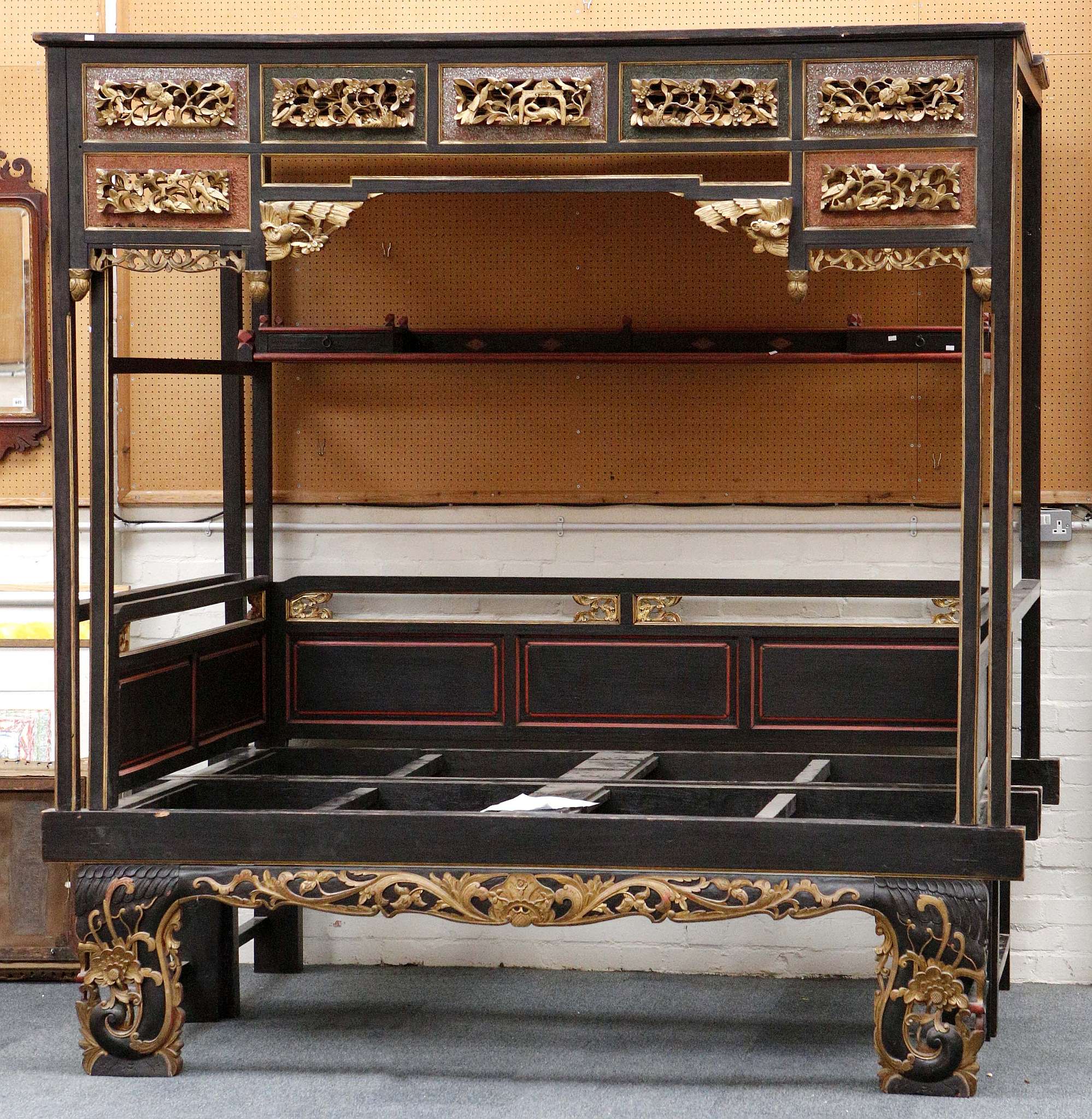 A Chinese four post canopy bed, Jiazichuang, with carved and pierced open-work panels to the top and