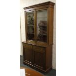 An early 20th century glazed book cupboard, mahogany, double doors over drawers and doors. 212cm