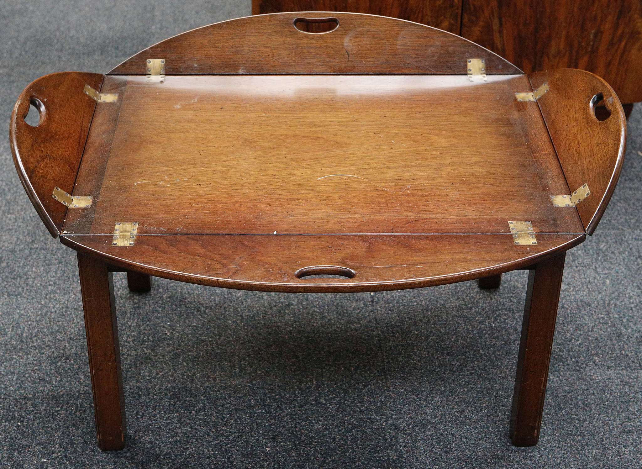 A hinged mahogany tray table, raised on square section legs. 100 x 80 x 45cm.