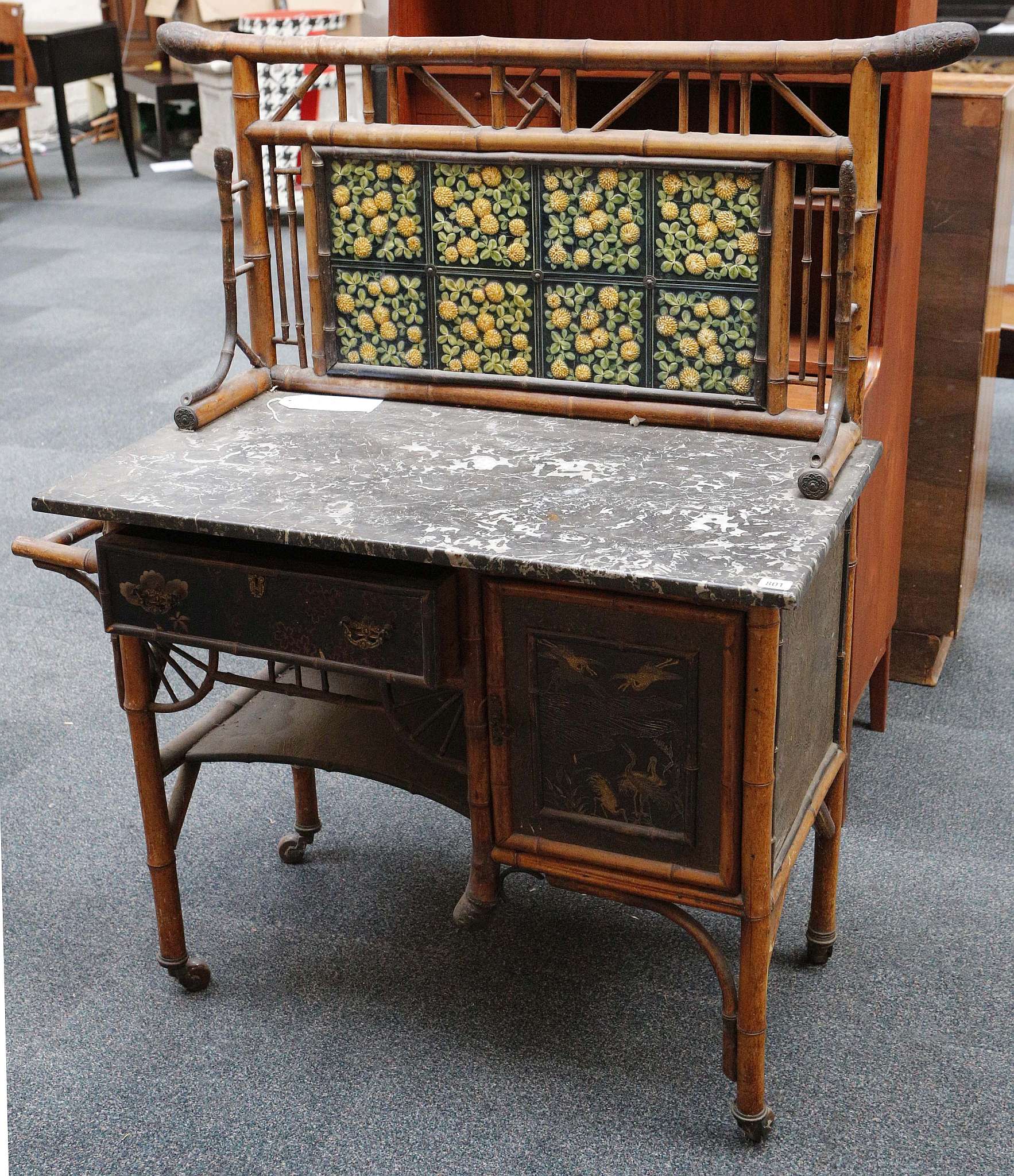 WITHDRAWN! A Victorian bamboo, tiled backed, grey marble wash stand with a cupboard and drawer,