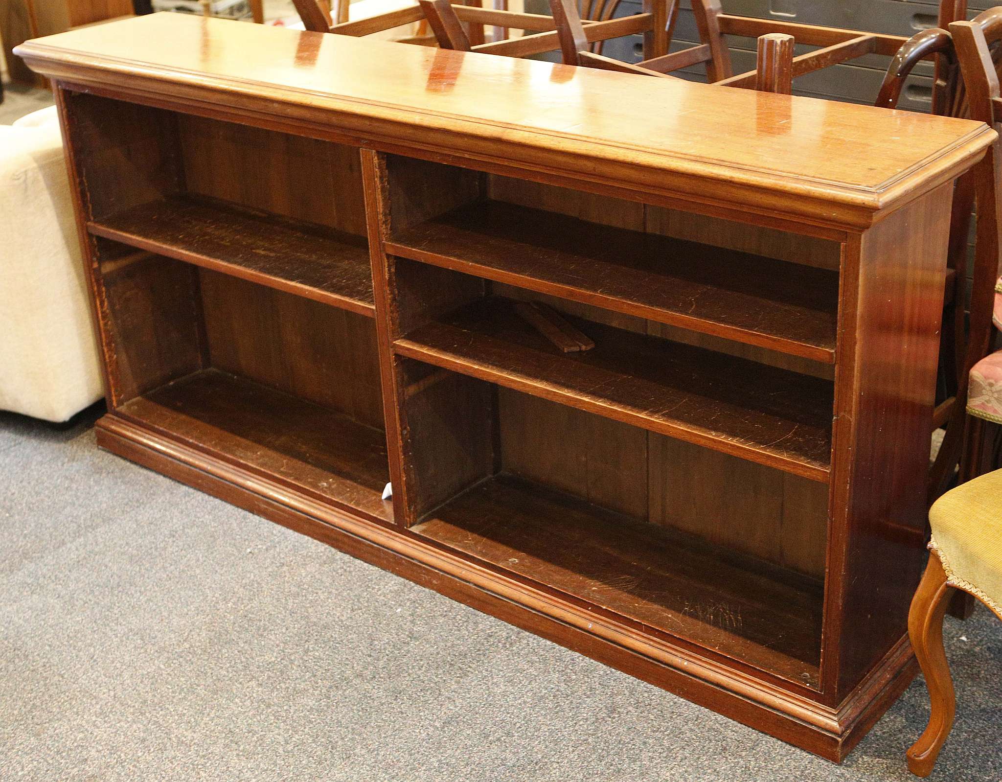 A mahogany bookcase of low form, open adjustable shelving, turn of the century. 88.5 x 183 x 36cm.