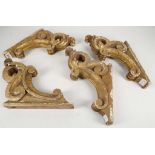 A set of 4, 19th Century, carved giltwood, scrolling curtain rail supports. (4).