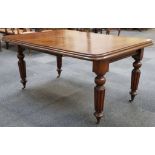A Victorian wind out dining table, mahogany, rounded corners, tapering turned and reeded legs, brass