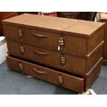 A modern leather clad chest of three long drawers with padlock handles, raised on a plinth. 81 x 140