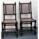 A pair of oak rattan chairs, turned finials, carving to back and seat, barley twist supports and