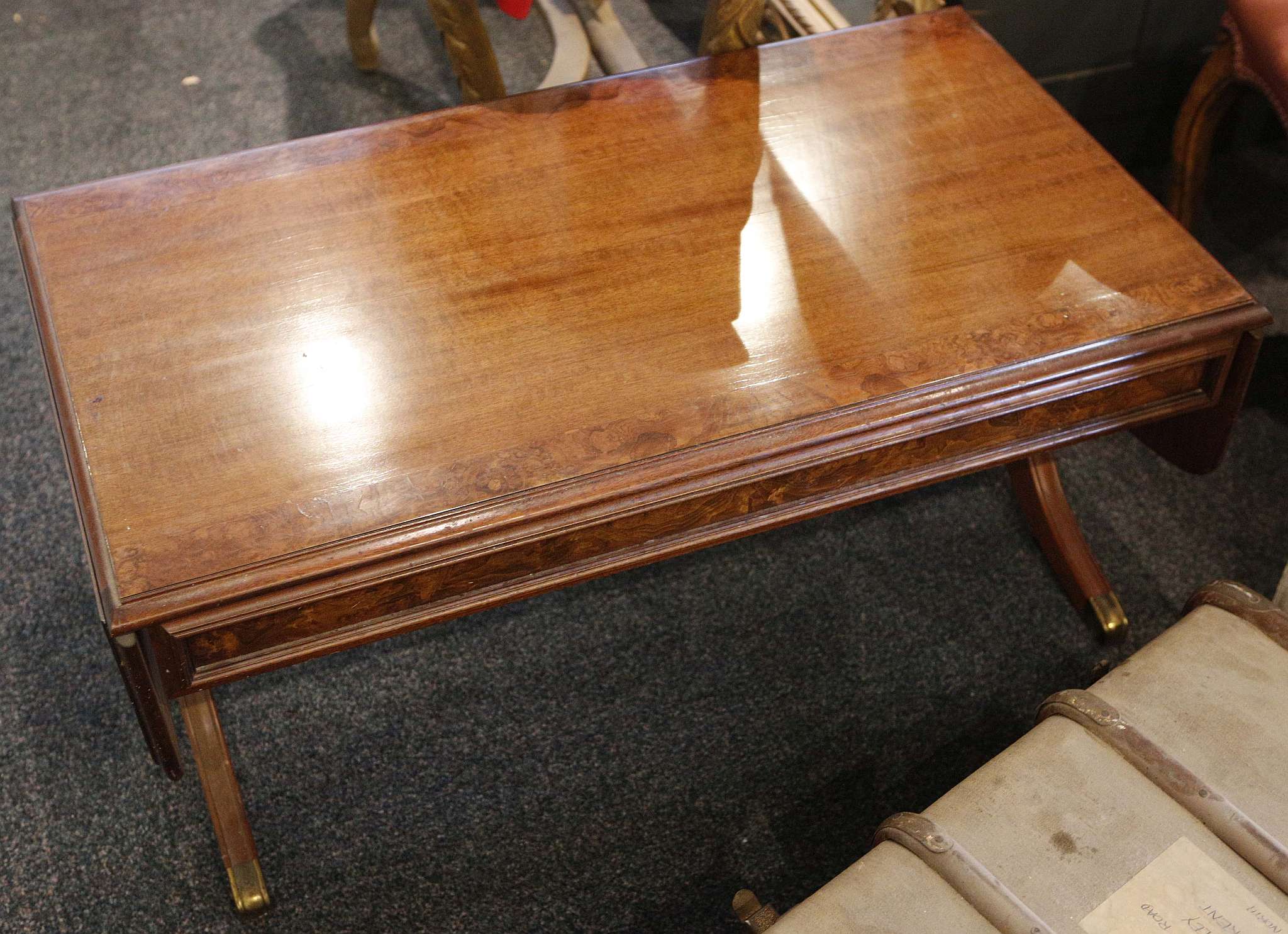 A sofa / coffee table, cross-banded walnut, drop ends, splay legs with turned stretcher, 120cm