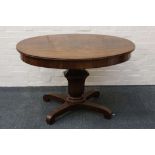 A Victorian oval centre table, flame mahogany with inlaid brass leaf detail, urn stem, quadripartite