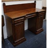 A 19th century Regency style pedestal sideboard, mahogany, carved scallop finial, flame pedestals