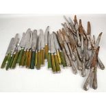 A collection of Georgian table knives, having silver tips and ferrules with green stained handles,