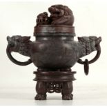 A Chinese stoneware carved incense burner, dog of Fo finial with temple ball, twin mask and ring