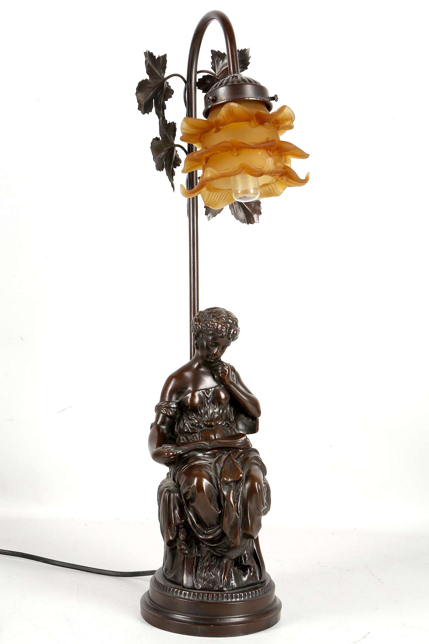 A bronzed Deco style figural table lamp with classical maiden seated with book, satin amber glass