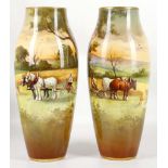 A pair of early 20th century, Royal Doulton porcelain cylindrical shaped vases. Both painted with