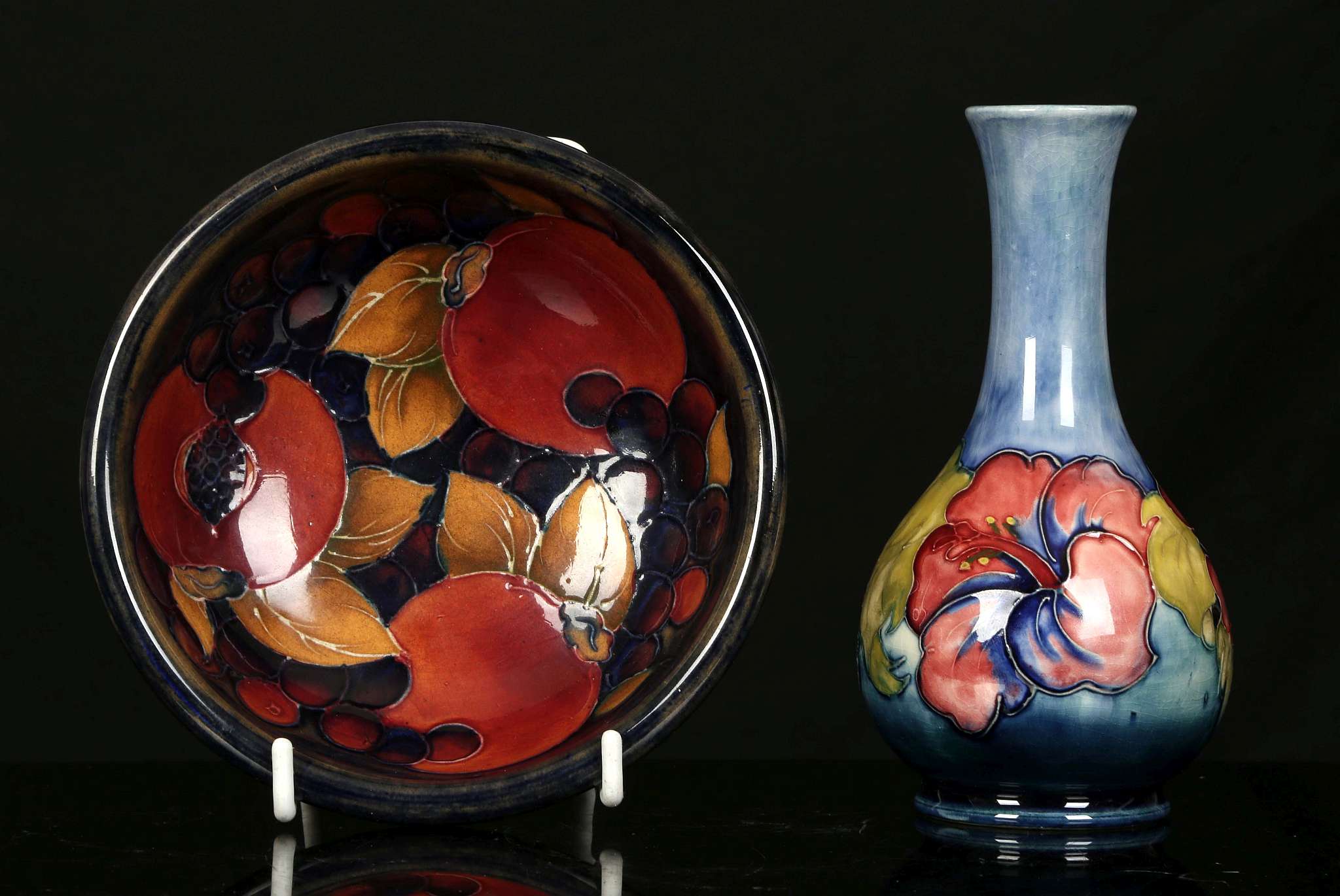 A WALTER MOORCROFT 'POMEGRANATE' DISH AND A BOTTLE VASE, mid 20th century, the dish decorated with