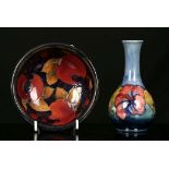 A WALTER MOORCROFT 'POMEGRANATE' DISH AND A BOTTLE VASE, mid 20th century, the dish decorated with