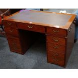 A Starbay twin pedestal desk with brown leather writing surface, with an arrangement of nine
