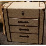 A Ralph Lauren style chest of drawers with an upholstered finish, comprising a lift up top and three