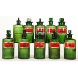 A SET OF TEN GREEN RIBBED GLASS APOTHECARY OR POISON BOTTLES AND STOPPERS, early 20th century,