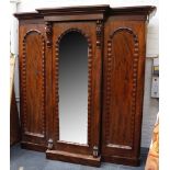 A late Victorian triple wardrobe, flame mahogany, wave beading, applied floral mounts, hanging units