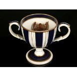 A CHARMING ENGLISH CREAMWARE LOVING CUP WITH A FROG, circa 1830, the cup-shaped form with a brown