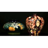 TWO CONTEMPORARY MOORCROFT VASES, comprising a squat vase decorated in the 'Passion Flower'