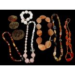 A collection of various Chinese and other hard-stone jewellery including a rose quartz and cluster