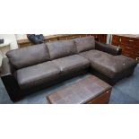 A brown leather corner unit with brown suede cushions, raised on block feet.