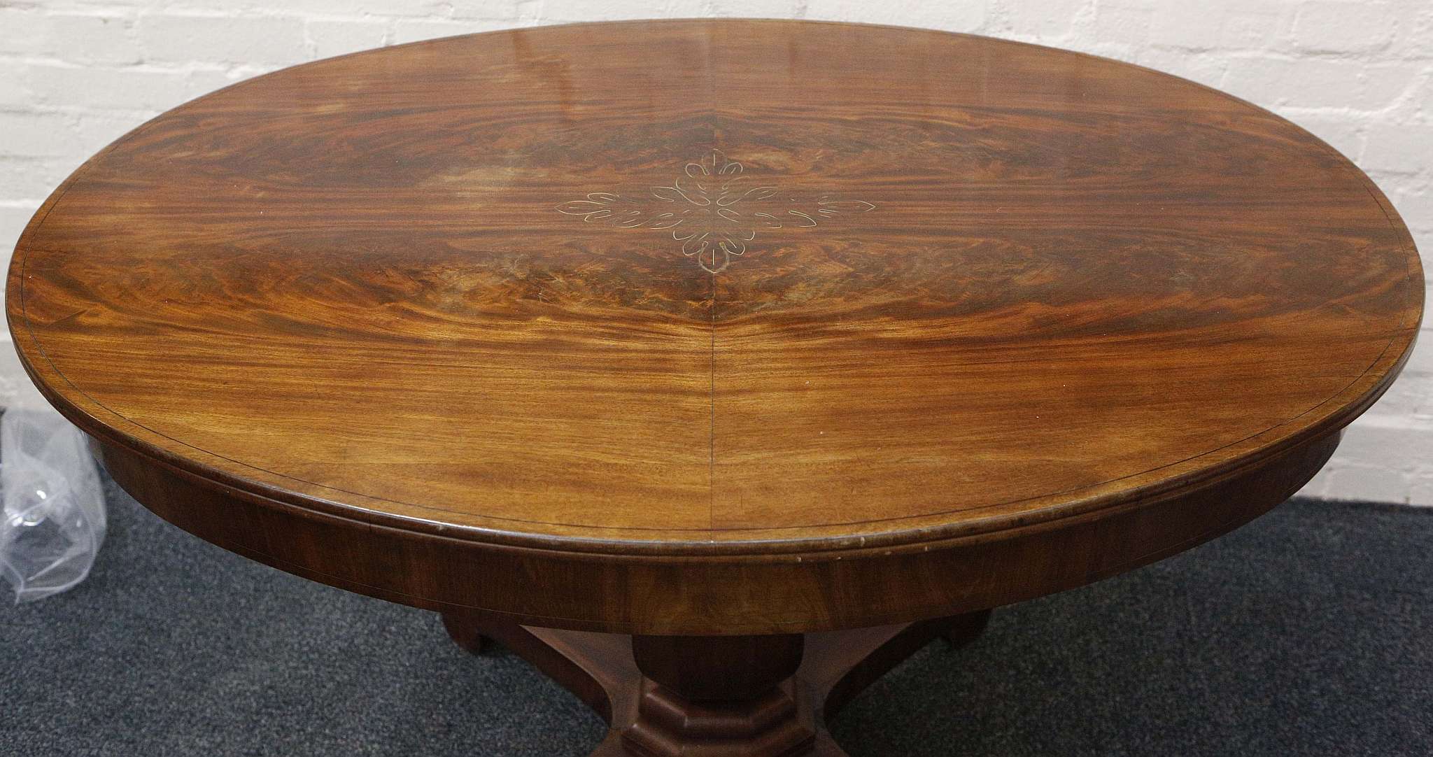 A Victorian oval centre table, flame mahogany with inlaid brass leaf detail, urn stem, quadripartite - Image 2 of 2