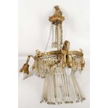 A French, late Empire chandelier, gilded leaf mounts, trailing floral band, floral swags and