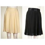 TWO GIANNI VERSACE COUTURE PLEATED SILK SKIRTS, one black the other cream, size 42 (2)