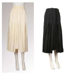 TWO CHANEL BOUTIQUE SILK SKIRTS, one black the other cream, ankle length with kick pleats, gilt