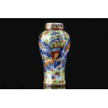 A CHINESE CLOBBERED MINIATURE BLUE AND WHITE VASE.
Qing Dynasty.
Of octagonal section, decorated