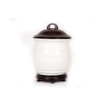 A CHINESE MONOCHROME WHITE BARREL-FORM JAR WITH ZITAN COVER.
Qing Dynasty, Qianlong mark and