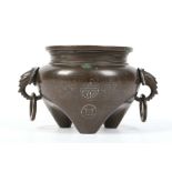 A CHINESE BRONZE SILVER INLAID ‘SHISOU’ CENSER.
With twin elephant head handles each suspending a